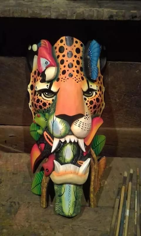 A hand-carved and painted Boruca jaguar mask from the Uvita market, one of several hanging in Casa Rosa Blanca