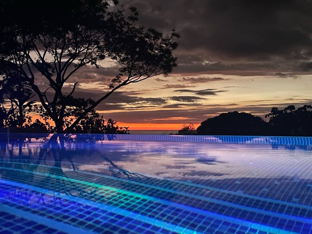 Purple and pink dusk sky reflected in the infinity pool, Ojochal, Costa Rica