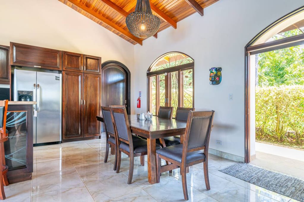 Indoor dining table seating six beside the kitchen