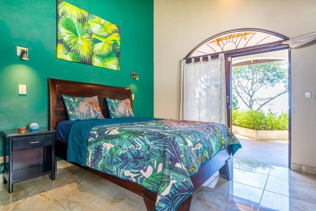 Jungle Room with queen bed and doors opening onto the garden