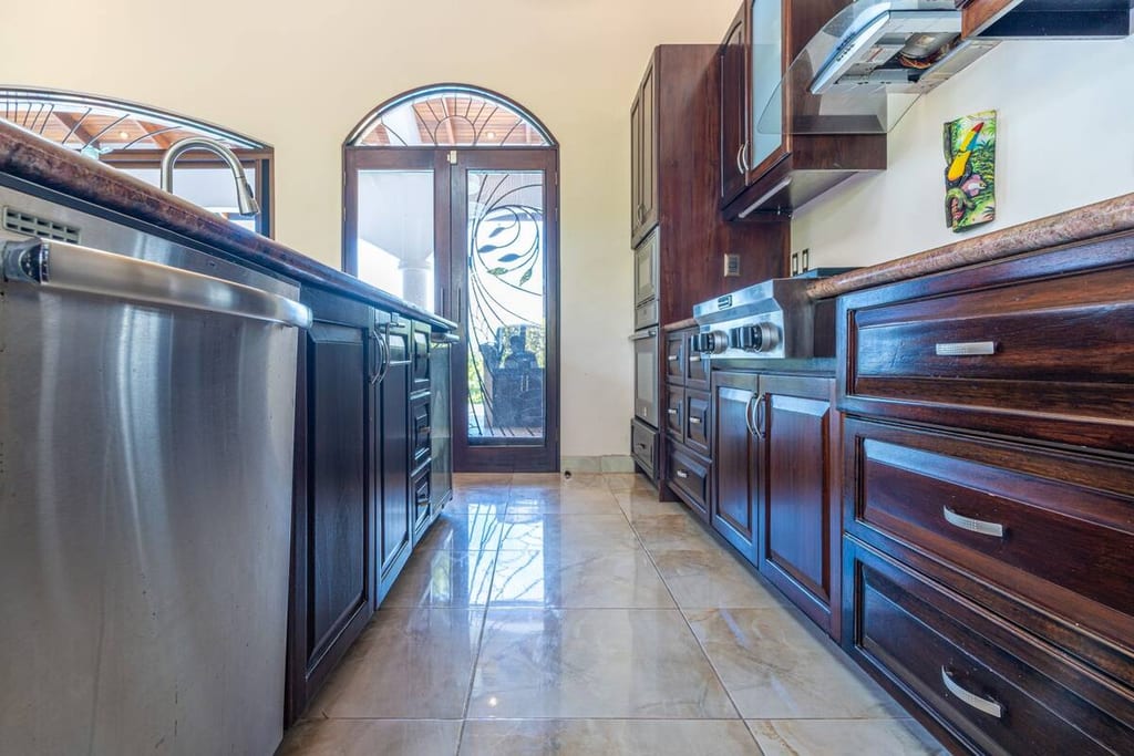 Kitchen with stainless appliances and gas cooktop, windows to the garden