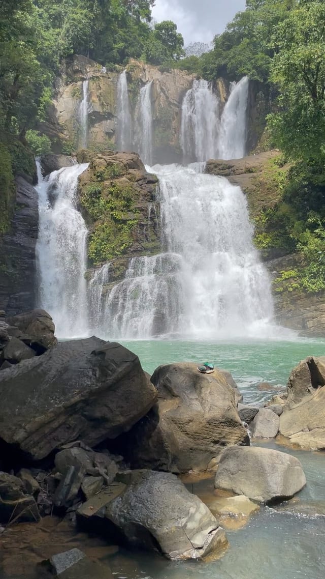 The twin tiers of Nauyaca Waterfalls falling into a turquoise pool, about 49 minutes by road from Casa Rosa Blanca in Ojochal, Costa Rica