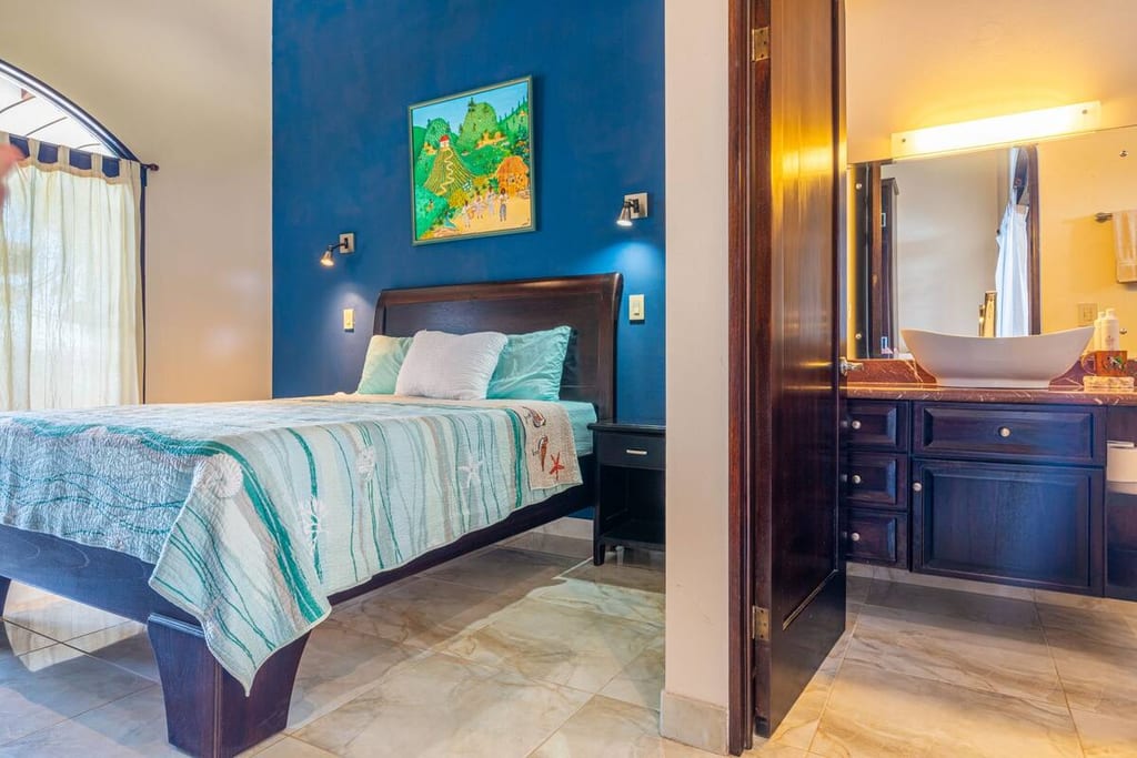 Ocean Room guest bedroom with its own ensuite bathroom visible through the doorway