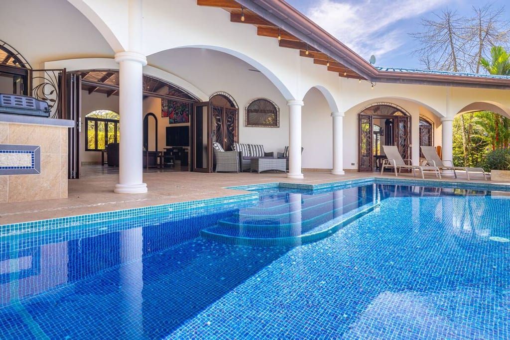 The infinity pool seen from inside the villa through its arched colonnade