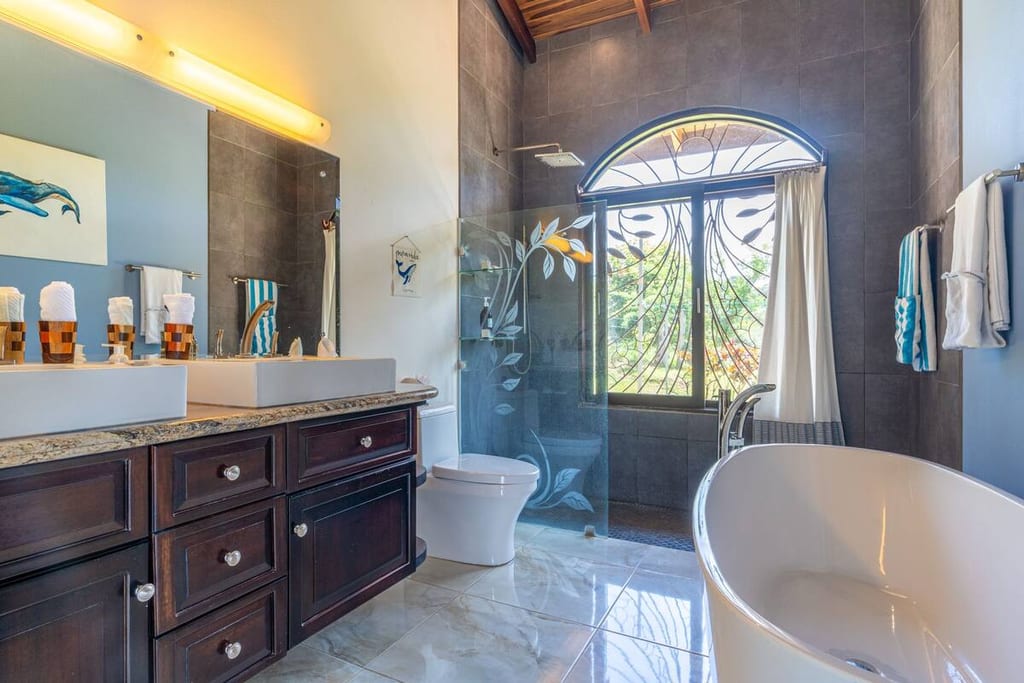 Primary ensuite bathroom with freestanding tub, walk-in shower and double vanity